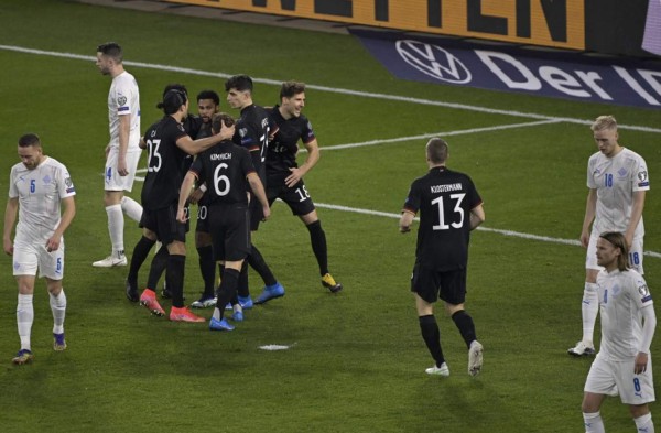 Germany's team celebrates the 1-0 during the FIFA World Cup Qatar 2022 qualification football match Germany v Iceland in Duisburg, western Germany on March 25, 2021. (Photo by Tobias SCHWARZ / various sources / AFP)