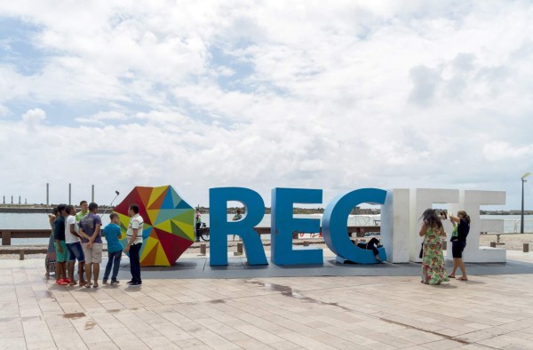 Recife, Pernambuco, Dec 19, 2015: The Recife Mile Zero city center receives a large number of tourists to visit the harbor and the buildings and streets of the old city. The city name sign is a meeting point.