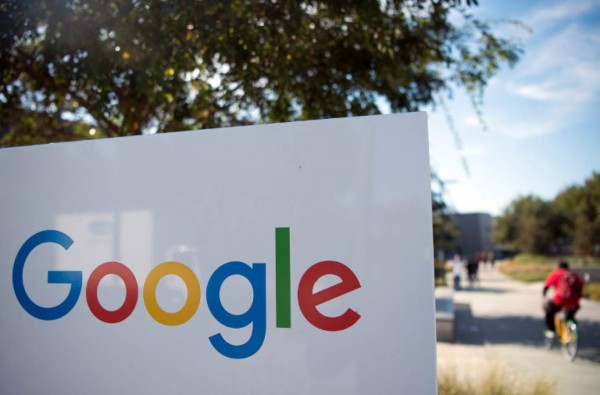 (FILES) In this file photo taken on November 4, 2016 a man rides a bike pass a Google sign and logo at the Googleplex in Menlo Park, California. Google on October 8, 2018 announced it is shutting down the consumer version of its online social network after fixing a bug exposing private data in as many as 500,000 accounts.The US internet giant said it will 'sunset' Google+ social network for consumers, which failed to gain meaningful traction as a challenge to Facebook. / AFP PHOTO / JOSH EDELSON