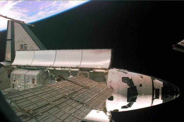 (FILES) In this file photo taken on May 18, 1997 the US Space Shuttle Atlantis is seen from the Russian Space Station Mir, with the planet earth in the background. The Atlantis and her seven-person crew greeted the Mir crew with a meal of foi gras and cassoulet delivered by a French astronaut after docking the at the space station with a new laser guidance system. NASA is celebrating its 60th anniversary. The National Aeronautics and Space Act, creating NASA, was signed into law by US President Dwight D. Eisenhower on July 29, 1958. / AFP PHOTO / NASA / HO / RESTRICTED TO EDITORIAL USE - MANDATORY CREDIT 'AFP PHOTO / NASA ' - NO MARKETING NO ADVERTISING CAMPAIGNS - DISTRIBUTED AS A SERVICE TO CLIENTS