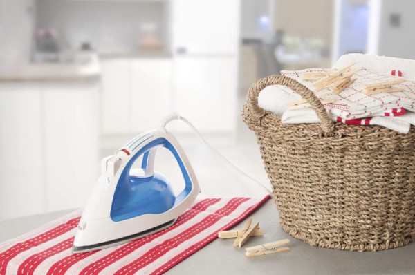 Laundry on ironing board in kitchen setting