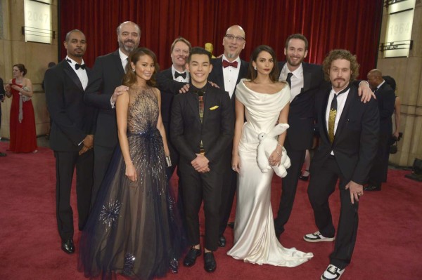 HOLLYWOOD, CA - FEBRUARY 22: (L-R) Actors Damon Wayans Jr., Scott Adsit, Jamie Chung, director Don Hall, actor Ryan Potter, producer Roy Conli, actress Genesis Rodriguez, director Chris Williams, and actor T.J. Miller attend the 87th Annual Academy Awards at Hollywood & Highland Center on February 22, 2015 in Hollywood, California. (Photo by George Pimentel/Getty Images)