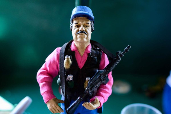 A statue of Mexican drug lord Joaquin 'El Chapo' Guzman, is displayed for sale at the narco-saint Jesus Malverde chapel in Culiacan, Sinaloa state in northwest Mexico, on July 15, 2019. - An air of sarcasm travels through Sinaloa, birthplace of the legendary Mexican drug lord Joaquin 'El Chapo' Guzman, before the imminent sentence of life imprisonment that he will receive this Wednesday in the United States. Inhabitants of this arid region who consider him their benefactor assure that neither the violence nor drug trafficking will diminish. (Photo by Pedro PARDO / AFP)