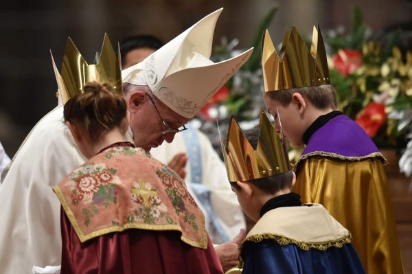 Pope Francis (L) and children dressed as Magi attend a mass at St Peter's basilica on January 1st, 2016 at the Vatican. AFP PHOTO / ALBERTO PIZZOLI