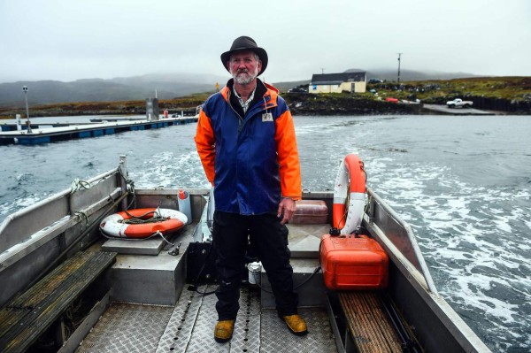 Donald Munro, operator of the Ulva Ferry takes visitors across to the Isle of Ulva, off Scotland's west coast on October 20, 2017. When tycoons in helicopters began landing on Scotland's Isle of Ulva, its five tenants feared their way of life might be coming to an end. The remote island of pristine beaches, lush hills and craggy coastlines was put on the market this year after decades of ownership by an aristocratic family. / AFP PHOTO / ANDY BUCHANAN / TO GO WITH AFP STORY by Mark McLaughlin