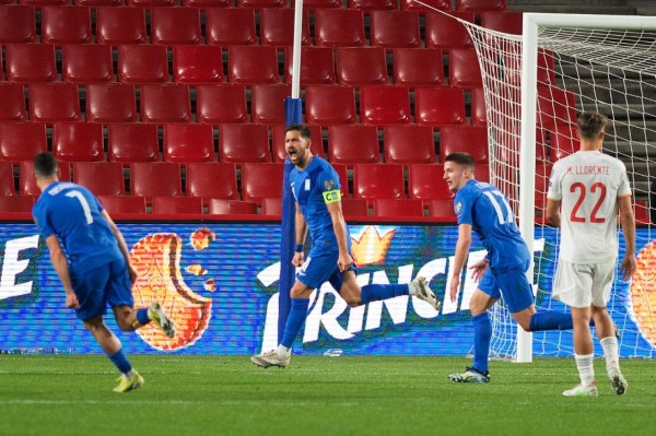 Greece's midfielder Anastasios Bakasetas (C) celebrates after scoring during the FIFA World Cup Qatar 2022 qualification football match between Spain and Greece on March 25, 2021 at Los Carmenes stadium in Granada. (Photo by JORGE GUERRERO / AFP)