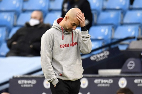 Manchester City's Spanish manager Pep Guardiola reacts during the English Premier League football match between Manchester City and Manchester United at the Etihad Stadium in Manchester, north west England, on March 7, 2021. (Photo by PETER POWELL / POOL / AFP) / RESTRICTED TO EDITORIAL USE. No use with unauthorized audio, video, data, fixture lists, club/league logos or 'live' services. Online in-match use limited to 120 images. An additional 40 images may be used in extra time. No video emulation. Social media in-match use limited to 120 images. An additional 40 images may be used in extra time. No use in betting publications, games or single club/league/player publications. /