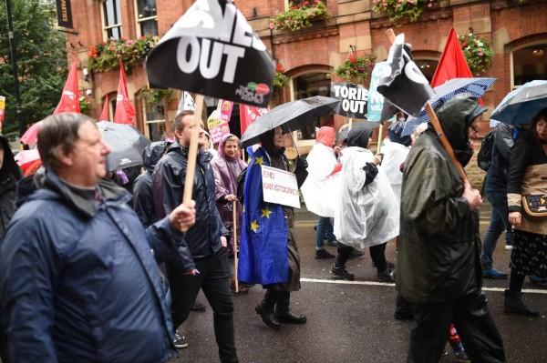 Demonstrators march during a protest to coincide with the Conservative Party's annual conference, in central Manchester on September 29, 2019, organised by The People's Assembly Against Austerity. - Embattled British Prime Minister Boris Johnson gathered his Conservative party Sunday for what could be its final conference before an election, promising to 'get Brexit done'. Despite a string of parliamentary setbacks and a defeat in the Supreme Court, Johnson insists he will take Britain out of the European Union next month, with or without a deal with Brussels. (Photo by Oli SCARFF / AFP)