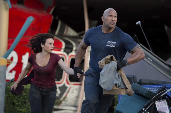 UNDATED -- BC-HOLLYWOOD-WATCH-DWAYNE-JOHNSON-ART-NYTSF -- Dwayne Johnson and Carla Gugino run for safety in the 2015 earthquake drama “San Andreas.” A sequel is in the works. (CREDIT: Photo by Jasin Boland. Copyright 2015 Warner Bros.)--ONLY FOR USE WITH ARTICLE SLUGGED -- BC-HOLLYWOOD-WATCH-DWAYNE-JOHNSON-ART-NYTSF -- OTHER USE PROHIBITED.