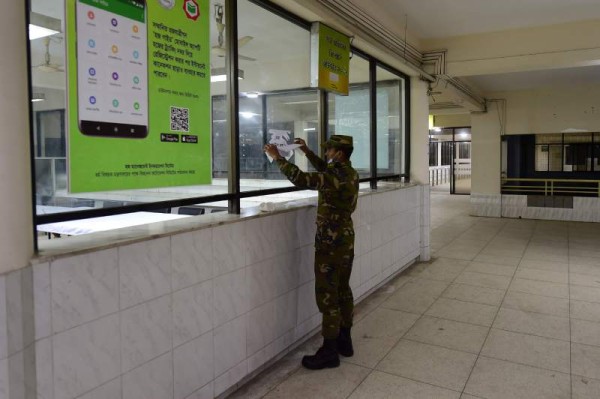 A Bangladeshi army personnel prepares a quarantine centre before the arrival of evacuated Bangladeshi nationals evacuated from the Chinese city of Wuhan, in Dhaka on February 1, 2020. - Authorities in Dhaka will send a special flight of Biman Bangladesh Airlines, the country's national carrier, to bring back 361 nationals, health ministry spokesman Maidul Islam said on January 31. Like most countries, Bangladesh will also quarantine the returnees for 14 days. (Photo by MUNIR UZ ZAMAN / AFP)