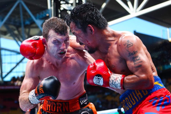 Pacquiao, que combina el combate con su actividad de senador, regresó a los rings en noviembre, después de siete meses fuera de ellos. /Manny Pacquiao (der.) y Jeff Horn (izq.)// Foto AFP/ Patrick HAMILTON