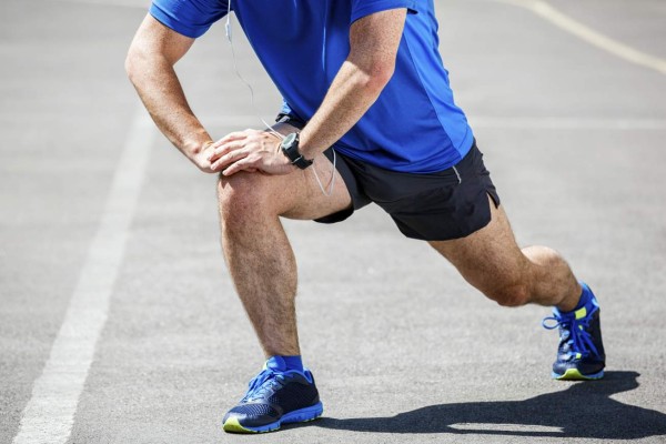 Male runner stretching before or after workout.