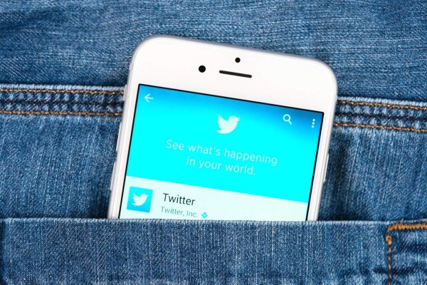33601582 - simferopol, russia - november 11, 2014: silver apple iphone 6 in jeans pocket displaying twitter application. twitter is an online social networking service that send and read messages
