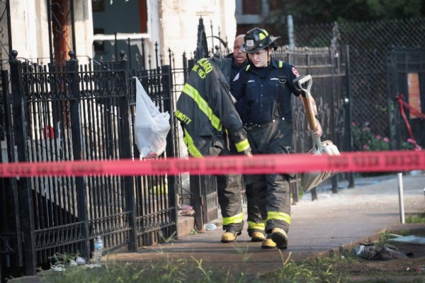 CHICAGO, IL - AUGUST 26: Firefighters continue to work at the scene of a residential fire where eight people perished, including six children, on August 26, 2018 in Chicago, Illinois. Two additional victims of the fire remain in the hospital in critical condition. Scott Olson/Getty Images/AFP