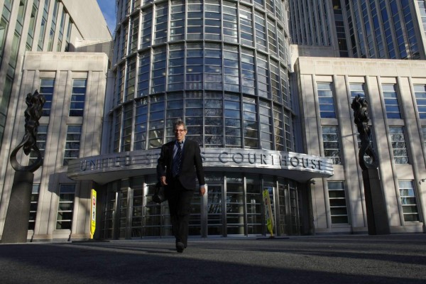 A man exits from the Federal District Court in Brooklyn, where Former Honduras President Rafael Callejas made a US court appearance on December 15, 2015 in New York. Callejas pleaded not guilty over his alleged role in the corruption scandal shaking world football's governing body FIFA. AFP PHOTO/KENA BETANCUR