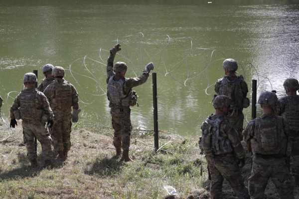 HIDALGO, TX - NOVEMBER 02: U.S. Army soldiers from Ft. Riley, Kansas install protective wire along the Rio Grande at the U.S.-Mexico border on November 2, 2018 in Hidalgo, Texas. U.S. President Donald Trump ordered the troops to the border to bolster security at points of entry where an immigrant caravan may attempt to cross in upcoming weeks. The troops in Hidalgo were from the 97th MP Battalion and had arrived to the Rio Grande Valley the day before. John Moore/Getty Images/AFP