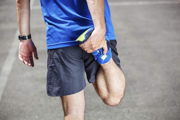 Male runner stretching before or after workout.