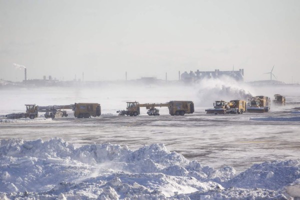BOSTON, MA - JANUARY 05: Snow removal equipment operators work the taxiway and runways at Logan International Airport following a 'bomb cyclone' the previous day on January 5, 2018 in Boston, Massachusetts. Hundreds of flights were cancelled and delayed because of the storm. Scott Eisen/Getty Images/AFP
