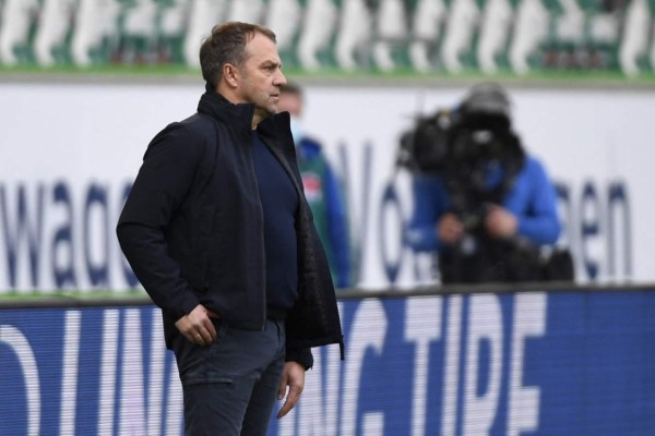 Bayern Munich's German head coach Hans-Dieter Flick reacts during the German first division Bundesliga football match between VfL Wolfsburg and FC Bayern Munich in Wolfsburg, northern Germany, on April 17, 2021. (Photo by FABIAN BIMMER / POOL / AFP) / DFL REGULATIONS PROHIBIT ANY USE OF PHOTOGRAPHS AS IMAGE SEQUENCES AND/OR QUASI-VIDEO