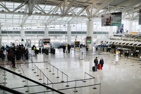 NEW YORK, NEW YORK - JANUARY 31: People walk through a nearly empty terminal at John F. Kennedy Airport (JFK) on January 31, 2020 in New York City. As fears grow around the globe over the Coronavirus, airlines and other travel industries are bracing for a sharp loss of business as people cut back on travel. The virus, which has so far killed over 200 people and infected an estimated 9,900 people, is believed to have started in the Chinese city of Wuhan. Spencer Platt/Getty Images/AFP== FOR NEWSPAPERS, INTERNET, TELCOS & TELEVISION USE ONLY ==