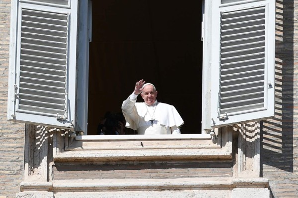 Pope Francis waves to the faithfuls from his window after the live-broadcast of his Sunday Angelus prayer at the Vatican on March 8, 2020, after millions of people were placed under forced quarantine in northern Italy as the government approved drastic measures in an attempt to halt the spread of the COVID-19 outbreak, caused by the novel coronavirus that is sweeping the globe. - On top of the forced quarantine of 15 million people in vast areas of northern Italy until April 3, the government has also closed schools, nightclubs and casinos throughout the country, according to the text of the decree published on the government website. With more than 230 fatalities, Italy has recorded the most deaths from the COVID-19 disease of any country outside China, where the outbreak began in December. (Photo by Alberto PIZZOLI / AFP)