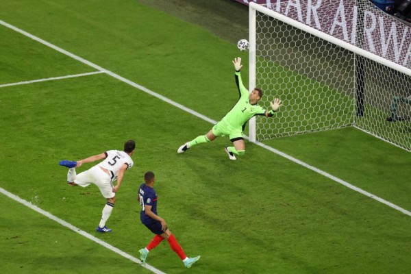 Germany's defender Mats Hummels (L) deflects the ball to score past Germany's goalkeeper Manuel Neuer for the first goal during the UEFA EURO 2020 Group F football match between France and Germany at the Allianz Arena in Munich on June 15, 2021. (Photo by ALEXANDER HASSENSTEIN / POOL / AFP)