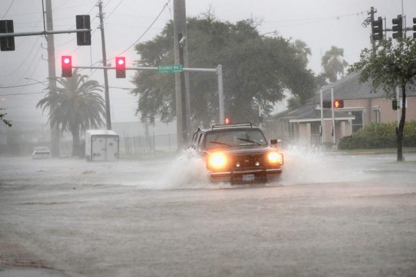 GALVESTON, TX - AUGUST 26: A vehicle navigates a street flooded by rain from Hurricane Harvey on August 26, 2017 in Galveston, Texas. Harvey, which made landfall north of Corpus Christi late last night, is expected to dump upwards to 40 inches of rain in Texas over the next couple of days. Scott Olson/Getty Images/AFP