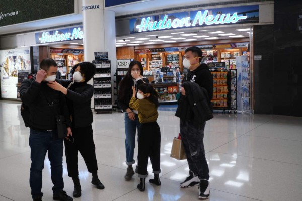 NEW YORK, NEW YORK - JANUARY 31: At the terminal that serves planes bound for China, people wear medical masks at John F. Kennedy Airport (JFK) out of concern over the Coronavirus on January 31, 2020 in New York City. The virus, which has so far killed over 200 people and infected an estimated 9,900 people, is believed to have started in the Chinese city of Wuhan. Spencer Platt/Getty Images/AFP== FOR NEWSPAPERS, INTERNET, TELCOS & TELEVISION USE ONLY ==