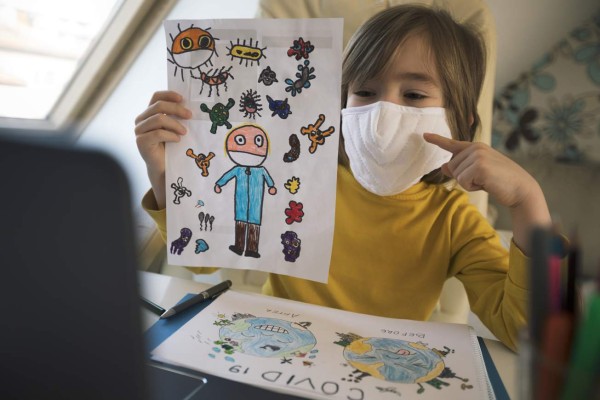 Little boy attending to online school class. Use mask. Coronavirus outbreak. E-learning platform. Stay home.
