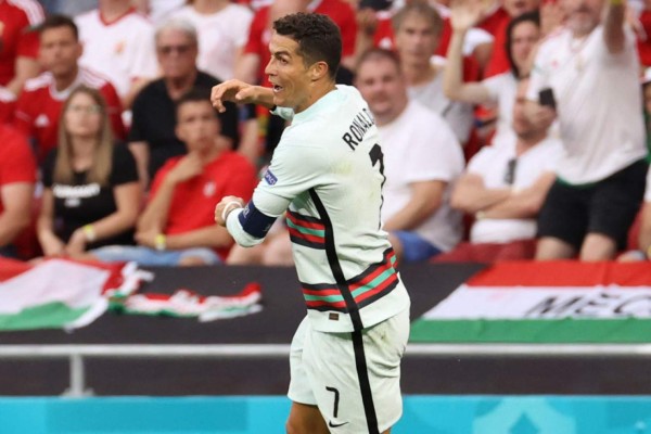 Portugal's forward Cristiano Ronaldo celebrates after scoring his team's third goal during the UEFA EURO 2020 Group F football match between Hungary and Portugal at the Puskas Arena in Budapest on June 15, 2021. (Photo by BERNADETT SZABO / various sources / AFP)