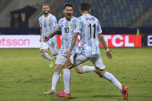 Argentina's Lionel Messi (L) celebrates with Argentina's Angel Di Maria after scoring against Ecuador during their Conmebol 2021 Copa America football tournament quarter-final match at the Olympic Stadium in Goiania, Brazil, on July 3, 2021. (Photo by NELSON ALMEIDA / AFP)
