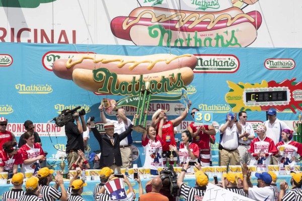 NEW YORK, NY - JULY 04: Miki Sudo celebrates after winning her fourth straight title in the women's division by eating 41 hot dogs in 10 minutes at the 2017 Nathan's Famous International Hot Dog Eating Contest at Coney Island on July 4, 2017 in New York City. Joey Chestnut won his 10th title by eating 72 hot dogs in 10 minutes. The contest in Coney Island is in it's 101th year. Alex Wroblewski/Getty Images/AFP