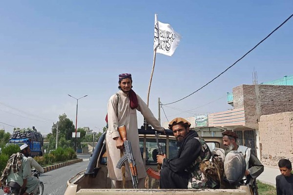 Taliban fighters drive an Afghan National Army (ANA) vehicle through the streets of Laghman province on August 15, 2021. (Photo by - / AFP)