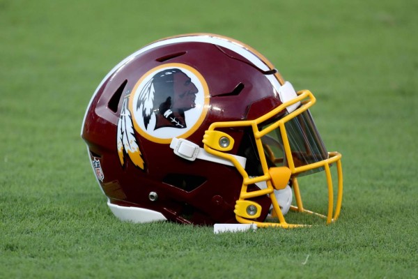 (FILES) In this file photo a Washington Redskins helmet sits on the grass before the start of the Redskins and Baltimore Ravens preseason game at M&T Bank Stadium on August 30, 2018 in Baltimore, Maryland. - The NFL's Washington Redskins will announce on July 13, 2020 they are changing their name, US media reported, following pressure from sponsors over a moniker widely criticized as a racist slur against Native Americans. Team owner Dan Snyder had long resisted calls to change the name, but came under renewed scrutiny as the United States saw massive rallies and campaigns erupt against racial injustice following the death in May of George Floyd, an unarmed African American man in police custody. (Photo by Rob Carr / GETTY IMAGES NORTH AMERICA / AFP)