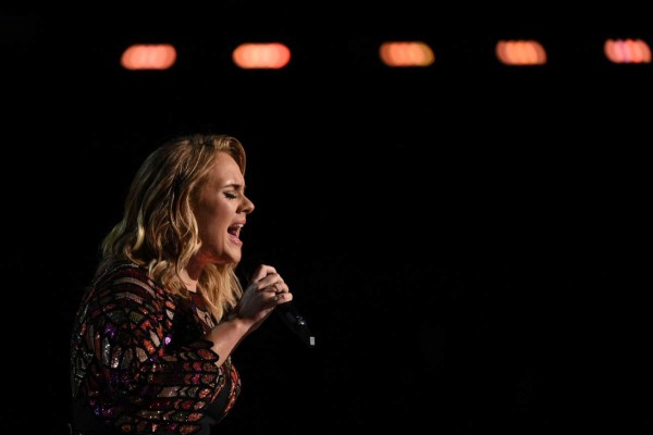 (FILES) This file photo taken on February 12, 2017 shows British singer Adele performs onstage during the 59th Annual Grammy music Awards, in Los Angeles, California. English balladeer Adele, one of the top-selling artists of the 21st century, says she may rtire from live performances as she winds up a massive tour. The 29-year-old singer thanked fans in a message on June 29, 2017 at London's Wembley Arena, where she is playing four final shows on a 123-date global tour. / AFP PHOTO / VALERIE MACON