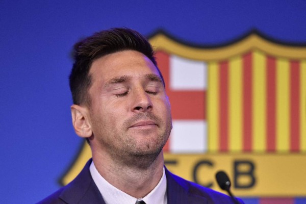 Barcelona's Argentinian forward Lionel Messi reacts during a press conference at the Camp Nou stadium in Barcelona on August 8, 2021. - Messi fought back tears as he began a press conference at which he confirmed he is leaving Barcelona, where he has played his entire career. (Photo by Pau BARRENA / AFP)