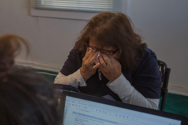 Gloria Eliza cries while applying for citizenship at the TODEC (Training Occupational Development Educating Communities) office on February 24, 2017 in Coachella, California.TODEC helps immigrants apply for citizenship and holds a workshop on legal issues for undocumented immigrants. / AFP PHOTO / DAVID MCNEW