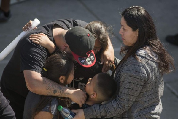SAN BERNARDINO, CA - APRIL 10: North Park Elementary School students and parents are reunited at Cajon High School after a shooting at their school on April 10, 2017 in San Bernardino, California. In what appears to be a murder-suicide, a teacher and the shooter, her husband, both died at the scene. An 8 year old boy died later at the hospital and another child is in stable condition. David McNew/Getty Images/AFP== FOR NEWSPAPERS, INTERNET, TELCOS & TELEVISION USE ONLY ==