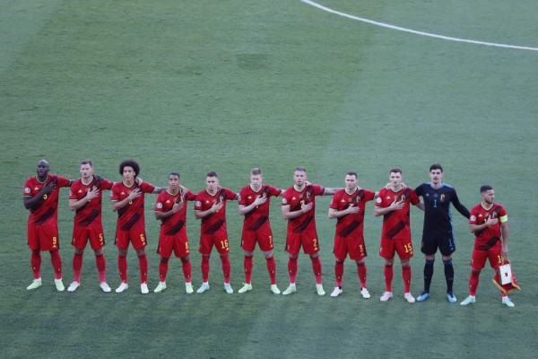 Belgium's players listen to their national anthem ahead of the UEFA EURO 2020 round of 16 football match between Belgium and Portugal at La Cartuja Stadium in Seville on June 27, 2021. (Photo by Jose Manuel Vidal / POOL / AFP)