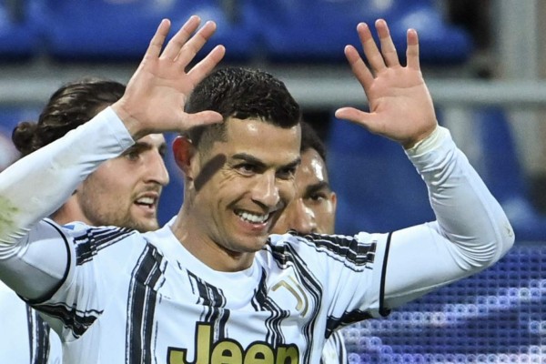 Juventus' Portuguese forward Cristiano Ronaldo celebrates after scoring his third goal during the Italian Serie A football match Cagliari vs Juventus on March 14, 2021 at the Sardegna Arena in Cagliari. (Photo by Alberto PIZZOLI / AFP)