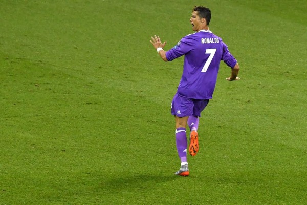 Real Madrid's Portuguese striker Cristiano Ronaldo celebrates after scoring the first goal during the UEFA Champions League final football match between Juventus and Real Madrid at The Principality Stadium in Cardiff, south Wales, on June 3, 2017. / AFP PHOTO / Ben STANSALL