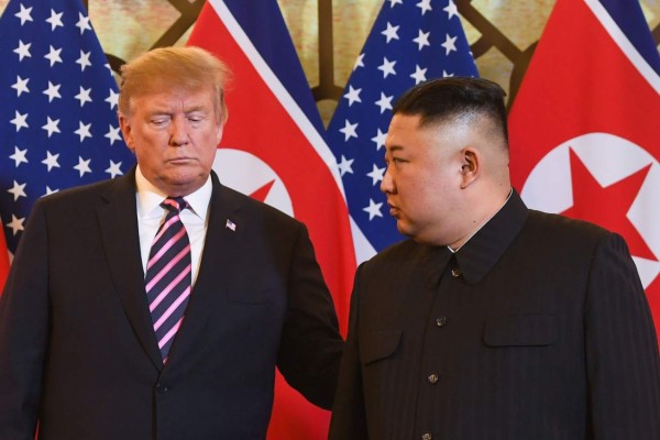 US President Donald Trump (L) and North Korea's leader Kim Jong Un arrive for a meeting at the Sofitel Legend Metropole hotel in Hanoi on February 27, 2019. (Photo by Saul LOEB / AFP)