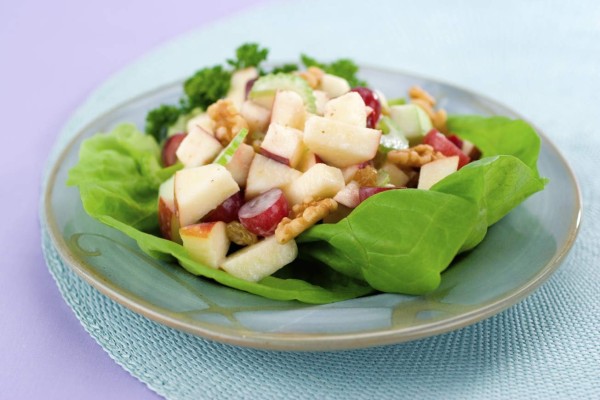 A classic waldorf salad made of apples, walnuts, grapes and celery served on butter lettuce. Shallow dof