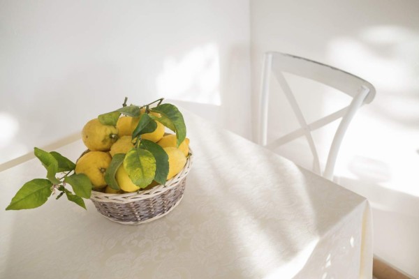 lemon wicker basket on a white tablecloth, copy space