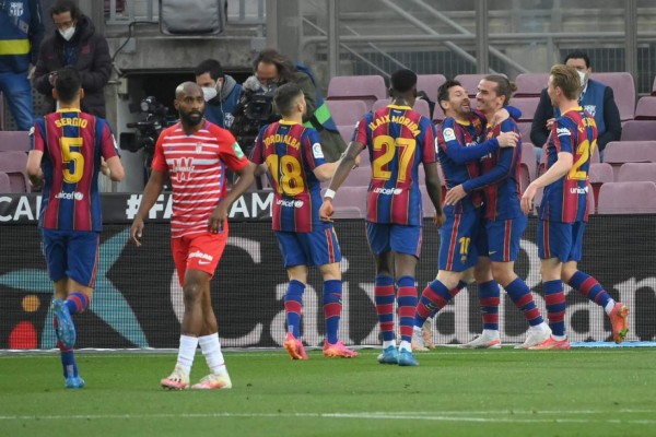 Barcelona's Argentinian forward Lionel Messi (3R) celebrates after scoring during the Spanish League football match between Barcelona and Granada at the Camp Nou stadium in Barcelona on April 29, 2021. (Photo by LLUIS GENE / AFP)