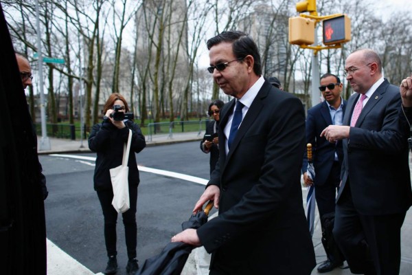 Former Honduran president Rafael Callejas leaves the Brooklyn federal court in New York, March 28, 2016 after pleading guilty to charges of racketeering conspiracy and wire fraud conspiracy in connection with the FIFA corruption scandal. / AFP PHOTO / KENA BETANCUR