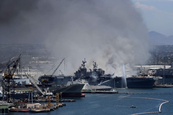 SAN DIEGO, CALIFORNIA - JULY 12: A fire burns on the amphibious assault ship USS Bonhomme Richard at Naval Base San Diego on July 12, 2020 in San Diego, California. There was an explosion on board the ship with multiple injuries reported. Sean M. Haffey/Getty Images/AFP== FOR NEWSPAPERS, INTERNET, TELCOS & TELEVISION USE ONLY ==