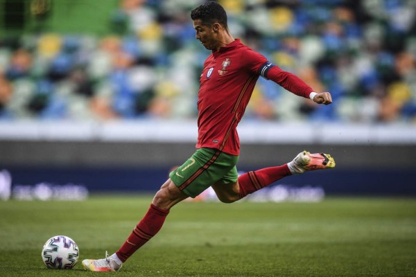 Portugal's forward Cristiano Ronaldo shoots during the international friendly football match between Portugal and Israel at the Jose Alvalade stadium in Lisbon in preparation for the UEFA EURO 2020 football competition, on June 9, 2021. (Photo by PATRICIA DE MELO MOREIRA / AFP)