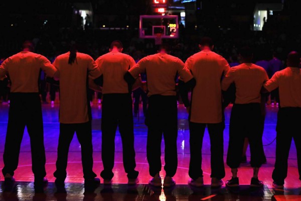 LOS ANGELES, CA - OCTOBER 02: The Denver Nuggets stand for a moment of silence to honor those killed in the Las Vegas shooting incident prior to a preseason game against the Los Angeles Lakers at Staples Center on October 2, 2017 in Los Angeles, California. NOTE TO USER: User expressly acknowledges and agrees that, by downloading and or using this Photograph, user is consenting to the terms and conditions of the Getty Images License Agreement Sean M. Haffey/Getty Images/AFP== FOR NEWSPAPERS, INTERNET, TELCOS & TELEVISION USE ONLY ==