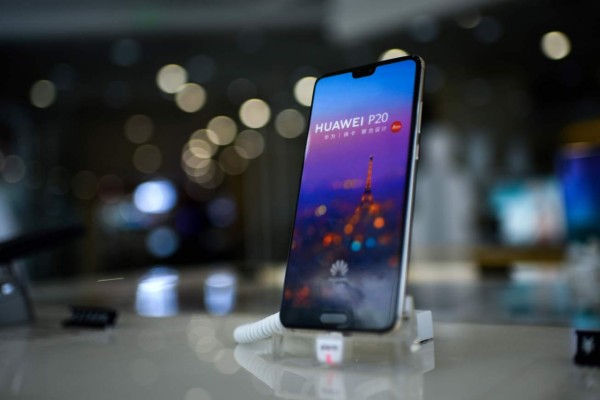 A Huawei smartphone is displayed at a Huawei store in Beijing on August 7, 2018.Despite being essentially barred from the critical US market, Huawei surpassed Apple to become the world's number two smartphone maker in the second quarter of this year and has market leader Samsung in its sights. Huawei has achieved this in part by refocusing away from the futile fight for US access and toward gobbling up market share in developing nations with its moderately priced but increasingly sophisticated phones, analysts said. / AFP PHOTO / WANG Zhao / TO GO WITH China-telecommunication-Huawei-mobile-Samsung-Apple,FOCUS by Dan Martin
